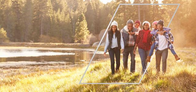 multigenerational family walking in forest